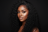Black woman wearing 22 inch raw 13x4 Burmese curl lace front wig